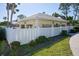 Exterior view of community building with a yellow facade and white trim at 404 Cerromar N Cir # 116, Venice, FL 34293