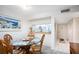Dining area with kitchen pass-through and view to entry at 404 Cerromar N Cir # 116, Venice, FL 34293