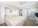 Spacious main bedroom with king-size bed and sliding door to balcony at 404 Cerromar N Cir # 116, Venice, FL 34293