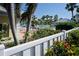 Community pool with lounge chairs, landscaping, and a white picket fence at 404 Cerromar N Cir # 116, Venice, FL 34293