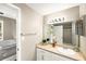Bathroom with vanity, large mirror, and view of bedroom at 4110 Central Sarasota Pkwy # 127, Sarasota, FL 34238