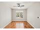 Spacious bedroom with hardwood floors and large window at 4110 Central Sarasota Pkwy # 127, Sarasota, FL 34238