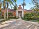 Community building with palm trees and parking at 4110 Central Sarasota Pkwy # 127, Sarasota, FL 34238