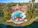 Aerial view of community pool with clubhouse and lush landscaping at 4110 Central Sarasota Pkwy # 127, Sarasota, FL 34238