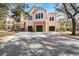 Two-story building exterior with attached garages and landscaping at 4110 Central Sarasota Pkwy # 127, Sarasota, FL 34238