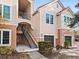 Townhome exterior showcasing staircase and two-car garage at 4110 Central Sarasota Pkwy # 127, Sarasota, FL 34238