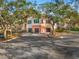 Two-story building exterior with attached garages and landscaping at 4110 Central Sarasota Pkwy # 127, Sarasota, FL 34238