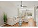Bright living room with sectional sofa, hardwood floors, and large windows at 4110 Central Sarasota Pkwy # 127, Sarasota, FL 34238