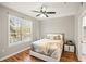 Main bedroom with hardwood floors, large windows, and modern bed at 4110 Central Sarasota Pkwy # 127, Sarasota, FL 34238