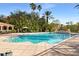 Inviting community swimming pool with surrounding lounge chairs at 4110 Central Sarasota Pkwy # 127, Sarasota, FL 34238