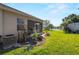 Landscaped backyard with pond view and screened patio at 4153 Lenox Blvd, Venice, FL 34293