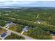 Wide aerial view of home, canal, and surrounding landscape at 419 Ramblewood St, Port Charlotte, FL 33953