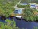 Aerial view of canal-front home with private pool and dock at 419 Ramblewood St, Port Charlotte, FL 33953