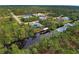 Aerial view showcasing canal-front home and dock at 419 Ramblewood St, Port Charlotte, FL 33953