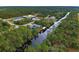 Aerial view showcasing canal-front home and dock at 419 Ramblewood St, Port Charlotte, FL 33953