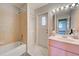 Bathroom with tub, shower, and pink vanity at 419 Ramblewood St, Port Charlotte, FL 33953