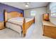 Main bedroom with king-size bed and wood furniture at 419 Ramblewood St, Port Charlotte, FL 33953