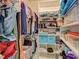 Well-organized walk-in closet with shelving and hanging rods at 419 Ramblewood St, Port Charlotte, FL 33953