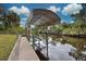 Covered boat dock on a peaceful canal at 419 Ramblewood St, Port Charlotte, FL 33953