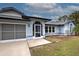 Home exterior showcasing screened entryway and attached garage at 419 Ramblewood St, Port Charlotte, FL 33953