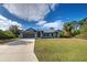 Front view of a single-story house with a spacious lawn at 419 Ramblewood St, Port Charlotte, FL 33953