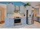 Modern kitchen with stainless steel appliances and gray cabinets at 419 Ramblewood St, Port Charlotte, FL 33953