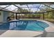 Pool area with screened enclosure and patio furniture at 419 Ramblewood St, Port Charlotte, FL 33953