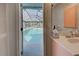 View of refreshing pool from bathroom at 419 Ramblewood St, Port Charlotte, FL 33953