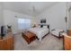 Spacious main bedroom with a king-size bed and seating area at 432 Sunset Lake Blvd # 201, Venice, FL 34292