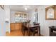 Bright dining area with wood table and four chairs near a built-in hutch at 458 Longwood Dr # 458, Venice, FL 34285