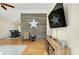 Living room boasts wood floors & a stylish accent wall at 49 Theresa Blvd, Port Charlotte, FL 33954