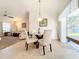 Small dining area with glass-top table and four off-white chairs at 5045 Pompano Rd, Venice, FL 34293