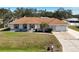 Single-story house with brown roof, white walls, and a landscaped yard at 5045 Pompano Rd, Venice, FL 34293