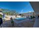 A swimming pool with blue tile is surrounded by seating and a two-story building with a white balcony at 509 W Venice Ave # 109, Venice, FL 34285