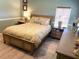 Comfortable bedroom with a queen bed and ample storage at 536 Amberjack Dr, North Port, FL 34287