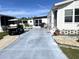 Paved driveway with golf cart and landscaping at 536 Amberjack Dr, North Port, FL 34287