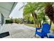Relaxing backyard patio with palm trees and seating at 555 Circlewood Dr # T10, Venice, FL 34293