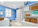Bathroom with white shelving, shower, and blue walls at 555 Circlewood Dr # T10, Venice, FL 34293