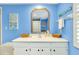 Bathroom with white vanity, blue walls, and shower at 555 Circlewood Dr # T10, Venice, FL 34293