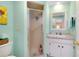 Mint green bathroom with white vanity and shower at 555 Circlewood Dr # T10, Venice, FL 34293