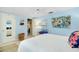 Bedroom with light blue walls, queen bed and floral art at 555 Circlewood Dr # T10, Venice, FL 34293