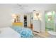 Bedroom with white dresser and blue patterned bedding at 555 Circlewood Dr # T10, Venice, FL 34293