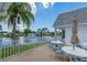 Community patio with tables, chairs, and umbrellas at 555 Circlewood Dr # T10, Venice, FL 34293