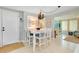 Small dining area with white table and four chairs at 555 Circlewood Dr # T10, Venice, FL 34293