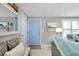 Bright entryway with light blue door and coastal decor at 555 Circlewood Dr # T10, Venice, FL 34293