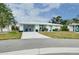Quaint Florida home with teal accents and a spacious driveway at 555 Circlewood Dr # T10, Venice, FL 34293