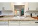 Kitchen sink and countertop with view into living room at 555 Circlewood Dr # T10, Venice, FL 34293
