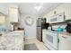 Clean kitchen with white cabinets and granite countertops at 555 Circlewood Dr # T10, Venice, FL 34293