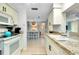 Open kitchen features white cabinets and dining area view at 555 Circlewood Dr # T10, Venice, FL 34293