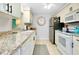Bright kitchen with stainless steel appliances and granite countertops at 555 Circlewood Dr # T10, Venice, FL 34293